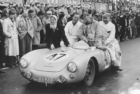 Zora&rsquo;s wife Elfi joins Zora and crew in celebrating 1954 class win at Le Mans in a Porsche 550.