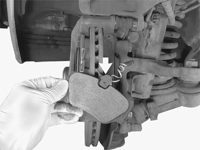 Apply small amount of Mercedes-Benz heat resistant paste to two edges of brake pad that make contact with guide channels in caliper and back of brake pad.
Insert pad wear sensor (arrow) in inner pad slot.
Insert new brake pads into pad carrier.
Chapter 3: Maintenance
page 71